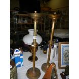 A pair of tall brass Eccliastical candle