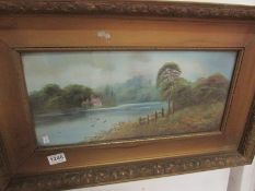 A framed and glazed watercolour lake sce