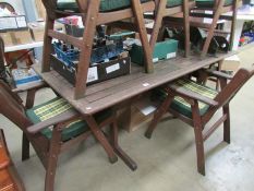 A garden table and 6 folding chairs