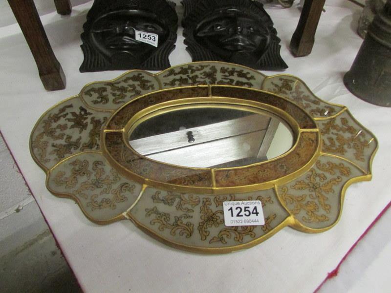 A decorated oval mirror