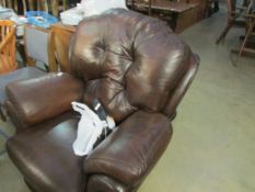A brown leather electric recliner chair