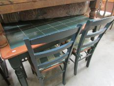 A tiled top dining table and 4 chairs