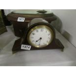 A mahogany mantel clock with brass inlay