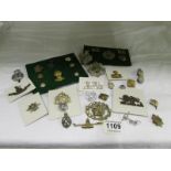 A quantity of military badges and button