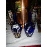 A pair of Bristol blue hand painted gilded glass urn vases