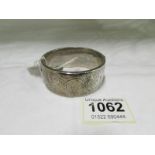 A silver bangle (50 gms)