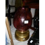 A brass oil lamp with cranberry glass shade - Font has been drilled for electric so won’t hold fuel