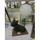 An Art Deco table lamp with a spelter terrier dog
