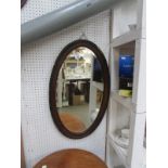An oval framed mirror
