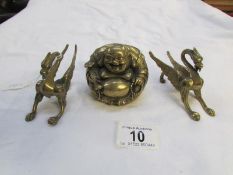A brass Buddha and a pair of brass drago