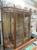 A beaded bow front display cabinet