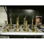 6 pair of Edwardian brass candlesticks