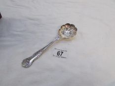 An ornate silver plated spoon