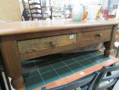 A heavy oak 2 drawer coffee table