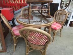 A cane table and 4 chairs