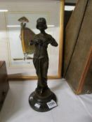 A 20th century bronze figure of a lady with garland