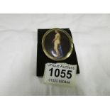 A tested gold pendant with a hand painted porcelain plaque of a nude lady