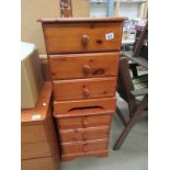 A pair of 3 drawer pine bedside chests