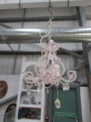 A small pink beaded ceiling light