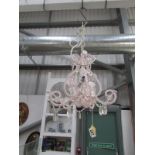 A small pink beaded ceiling light