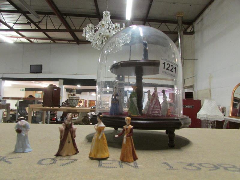 A small glass display dome with miniatur