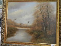 A gilt framed oil on canvas of ducks flying over pond signed Tovelli, image 60cm x 50cm, frame