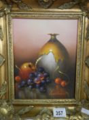 A gilt framed still life of jug and grapes signed Wallace, image 24cm x 19cm, frame 35cm x 30cm