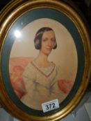 An oval framed and glazed watercolour portrait of a lady