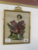 An embroidered portrait study in a gilt frame