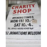 A painted metal charity shop advertising