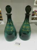 A pair of green and gilt spirit decanter