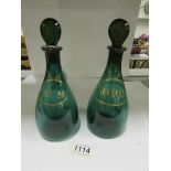 A pair of green and gilt spirit decanter