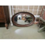 An oval bevel edged mirror