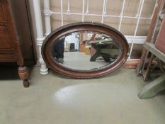 An oval bevel edged mirror