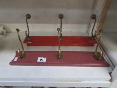 2 sets of brass coat hooks on wooden bac