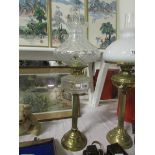 A brass oil lamp with glass font, chimne