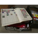 A box of assorted world stamp albums