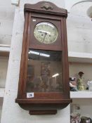 An oak wall clock, missing pendelum and