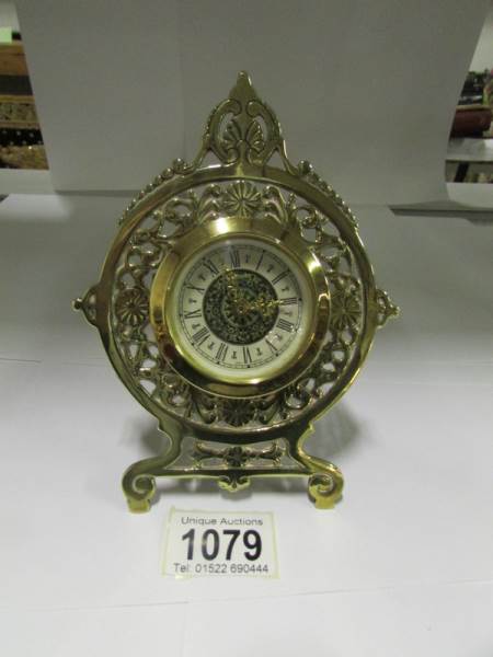 A small ornate brass clock marked 'Germa