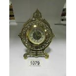 A small ornate brass clock marked 'Germa