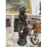 A large 'bronzed' figure of a lady beari