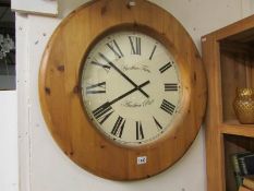 A modern circular pine wall clock