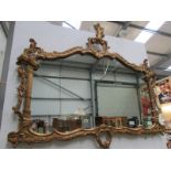 A large gilt framed over mantel mirror