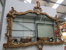 A large gilt framed over mantel mirror