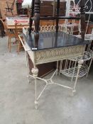 A metal wash stand with marble top