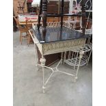 A metal wash stand with marble top