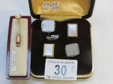 A pair of mother of pearl cufflinks and