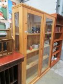 A pine 4 shelf glazed door bookcase