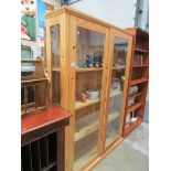 A pine 4 shelf glazed door bookcase