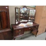 A dressing table with triple mirror